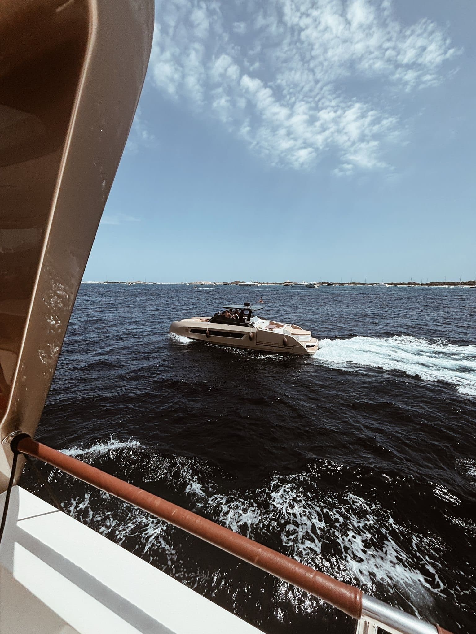 Professional crew sailing luxury yacht with sunset drinks on deck